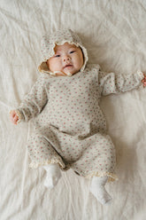 Baby lying down in the Mellow Rose bodysuit – highlighting the soft waffle knit fabric and comfortable fit.